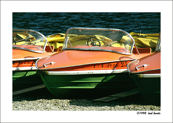 three small boats on dry land